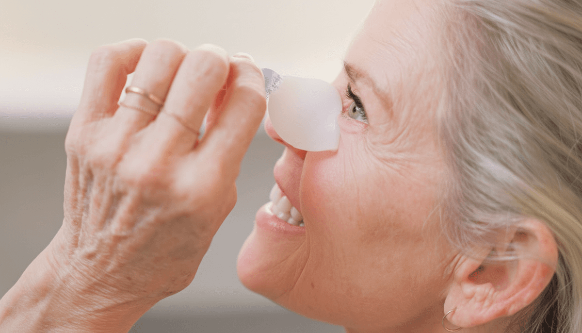 Woman removing OKO hydrogel eye shield